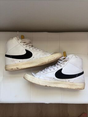 Nike White High-Top Sneakers with Black Swoosh and Yellow Heel Tab